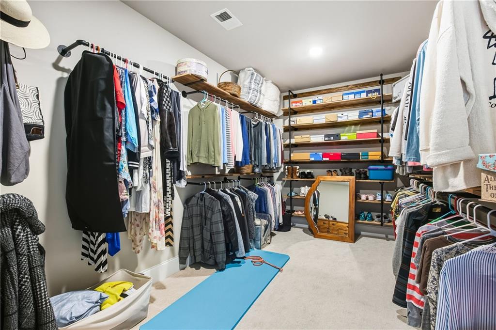 265 Fountain Oak Way Canton, GA 30114 - Photo 30 of 59 a view of walk in closet with clothes and shoes