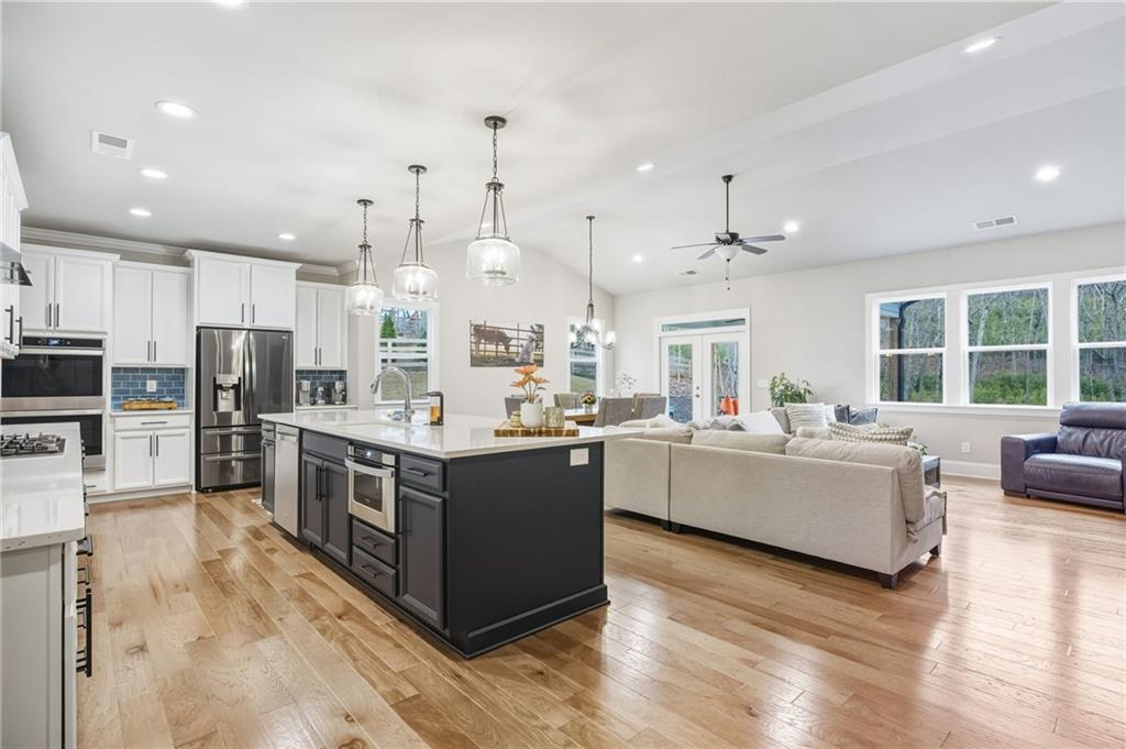 265 Fountain Oak Way Canton, GA 30114 - Photo 8 of 59 a large kitchen with stainless steel appliances lots of counter space and wooden floor