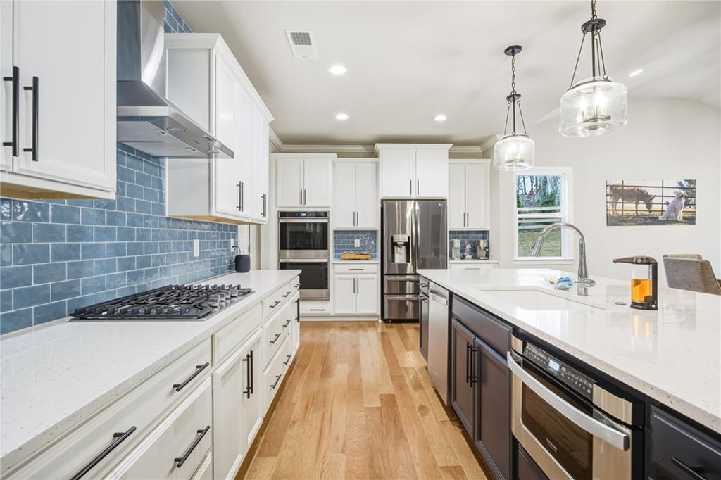 265 Fountain Oak Way Canton, GA 30114 - Photo 10 of 59 a kitchen with stainless steel appliances kitchen island granite countertop a sink stove refrigerator and cabinets