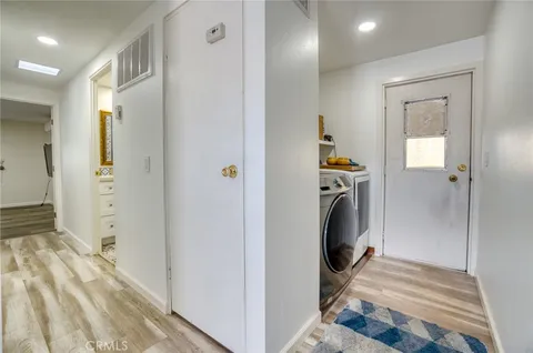 a view of a hallway with a washer and dryer