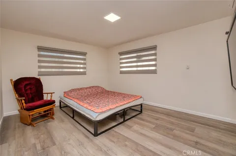 a bedroom with bed and flat screen tv