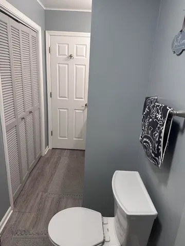 a bathroom with a toilet a sink and mirror