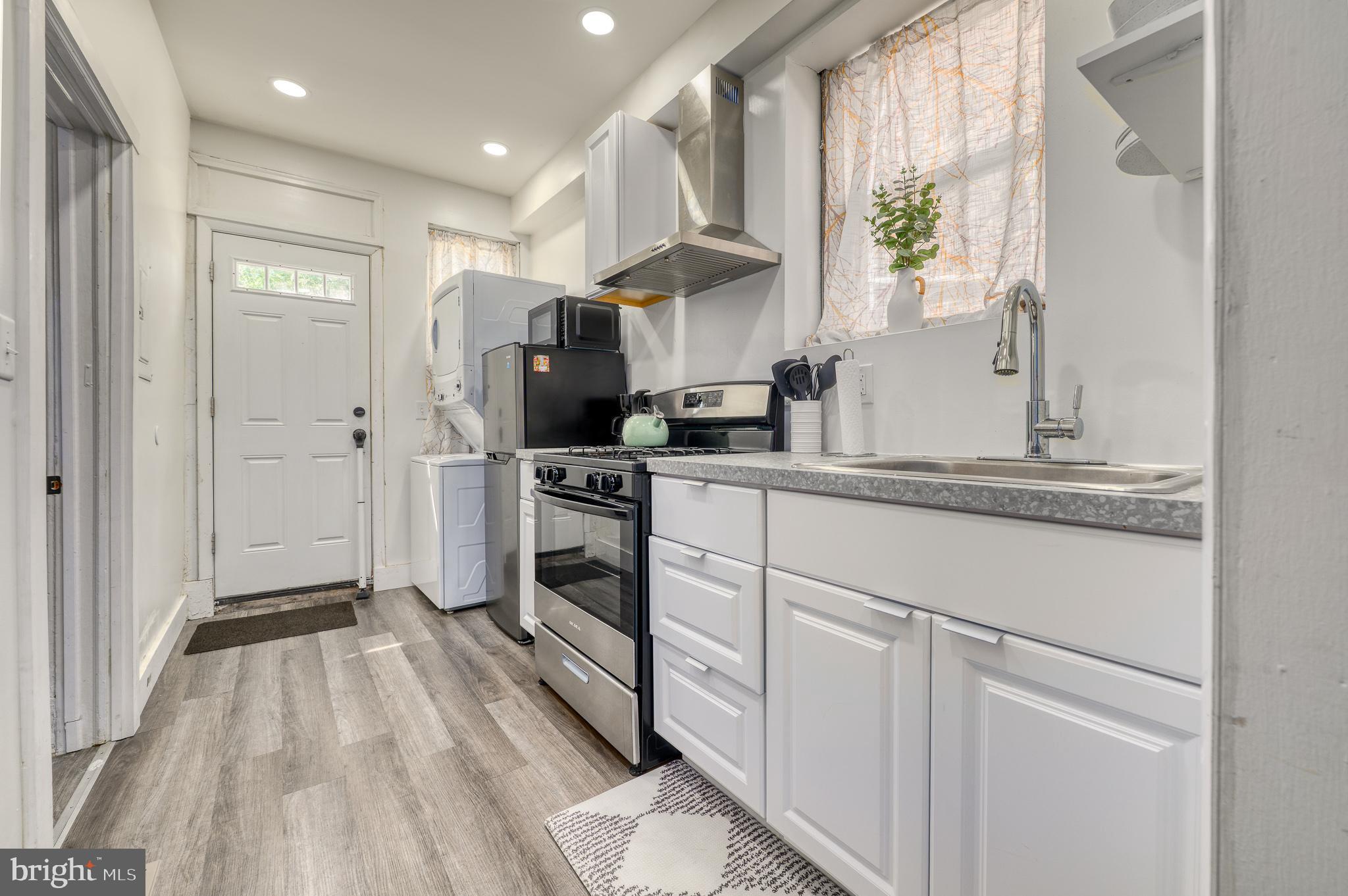 7104 Harford Road Baltimore, MD 21234 - Photo 26 of 37 a kitchen with a sink appliances and cabinets