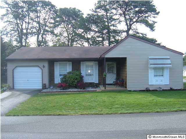 37 Stonybrook Road Whiting, NJ 08759 - Photo 1 of 3 a front view of a house with a yard and garage