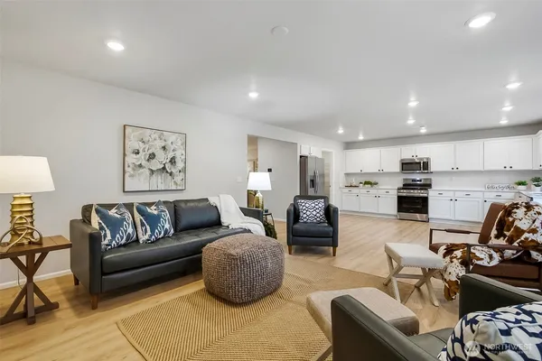 a living room with furniture kitchen view and a couch