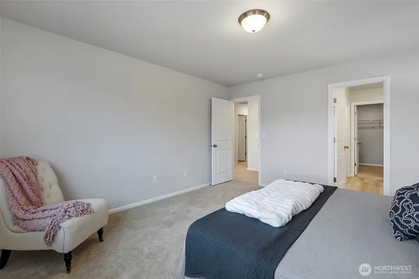 a bedroom with a bed and a couch