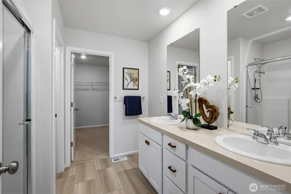 a bathroom with a double vanity sink and mirror