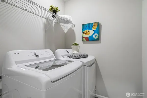 a bathroom with a sink a mirror and a picture on the wall