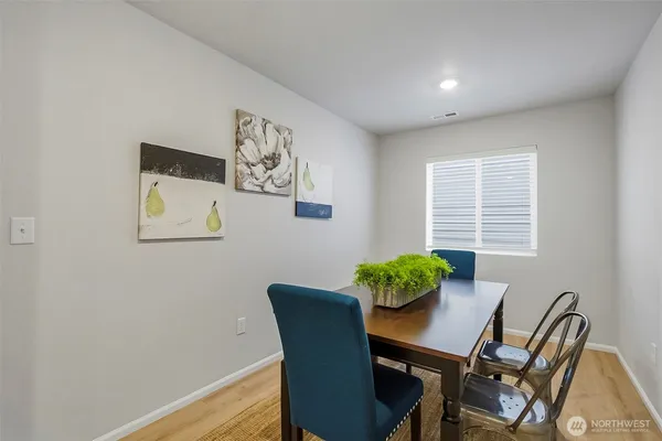 a view of a dining room with furniture and window