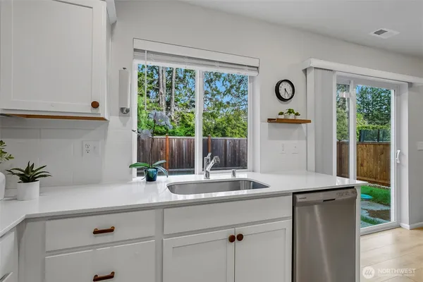 a room with a window a sink and a wooden floor