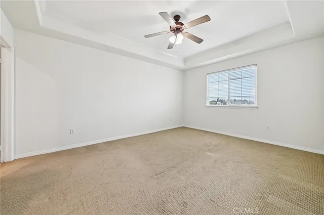 an empty room with a empty space and a ceiling fan
