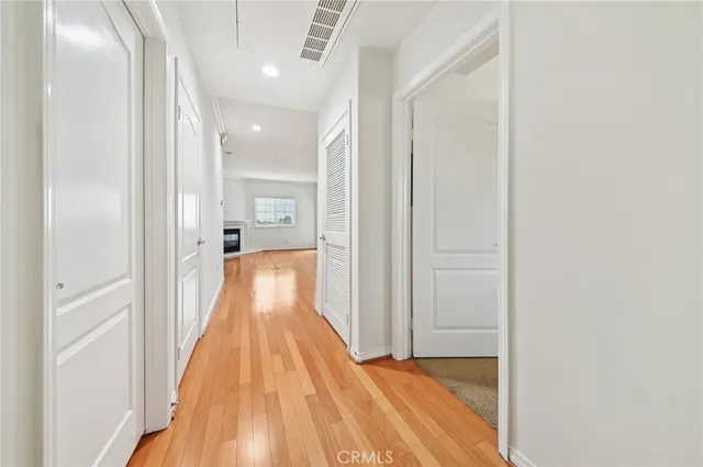 a view of a hallway with wooden floor