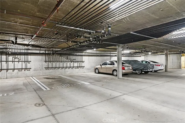 a view of parking garage with cars