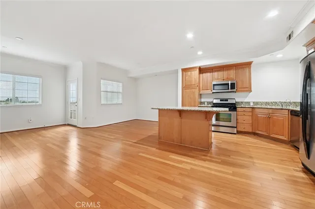 a kitchen with stainless steel appliances granite countertop a stove top oven a sink with granite countertops and cabinets