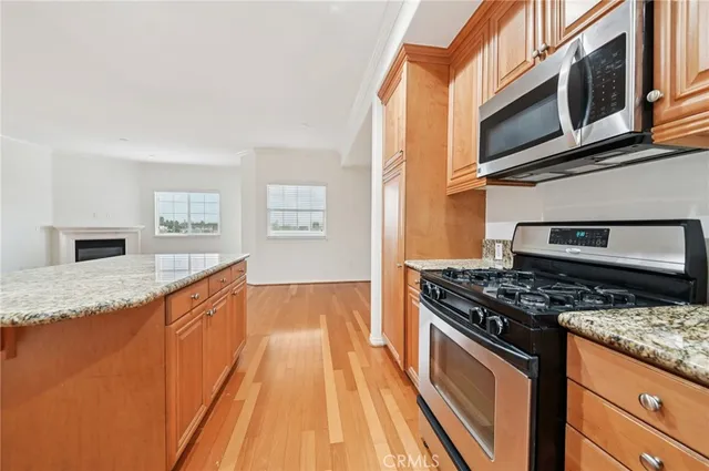 a kitchen with stainless steel appliances granite countertop a stove and a sink