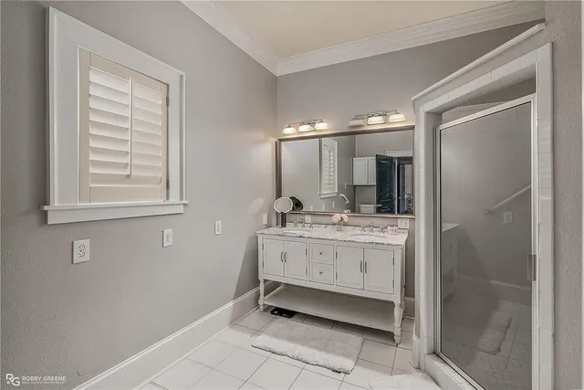 a bathroom with a double vanity sink mirror and shower