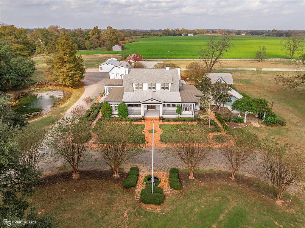 8265 Cornhusker Road Shreveport, LA 71107 - Photo 2 of 39 an aerial view of a house with a garden and lake view