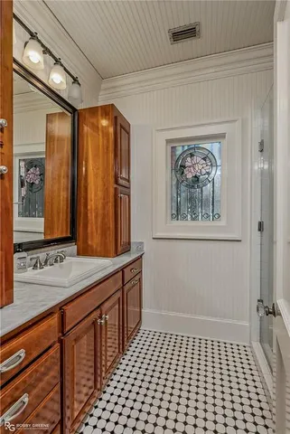 a bathroom with a sink a mirror and a shower