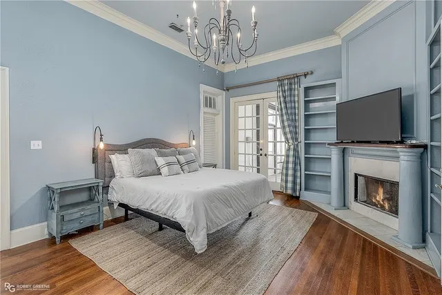 a spacious bedroom with a bed and a fireplace