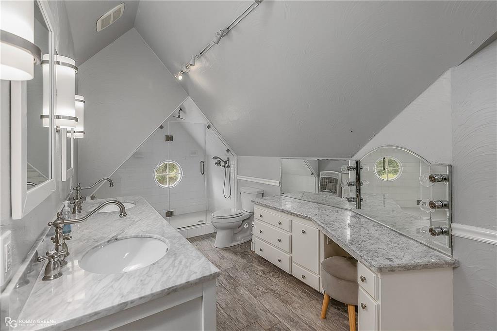 8265 Cornhusker Road Shreveport, LA 71107 - Photo 24 of 39 a spacious bathroom with a granite countertop sink and a mirror