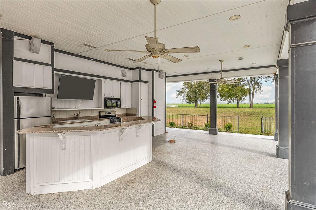 8265 Cornhusker Road Shreveport, LA 71107 - Photo 32 of 39 a large kitchen with stainless steel appliances granite countertop a stove and a refrigerator