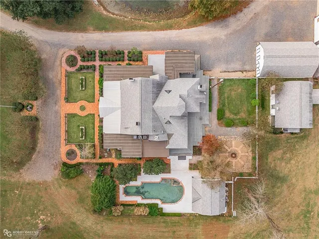 an aerial view of a house with a swimming pool