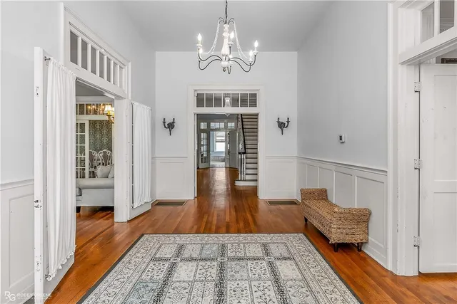 a view of a hallway with wooden floor and staircase