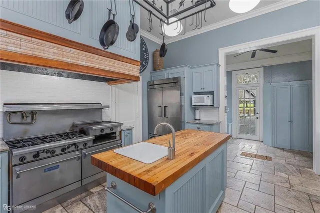 a kitchen with stainless steel appliances granite countertop a sink and cabinets