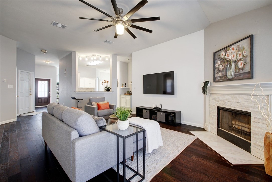 2415 Candle Ridge Trail Georgetown, TX 78626 - Photo 1 of 1 a living room with furniture a fireplace and a flat screen tv