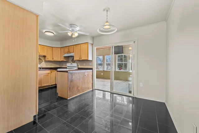 a kitchen with stainless steel appliances granite countertop a stove a sink and white cabinets