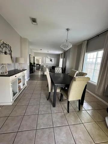 a living room with furniture a dining table and a stove