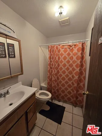 a bathroom with a sink toilet and a mirror