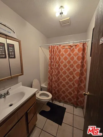a bathroom with a sink toilet and a mirror