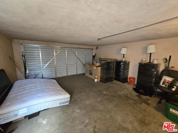 a bedroom with a bed and gym equipment