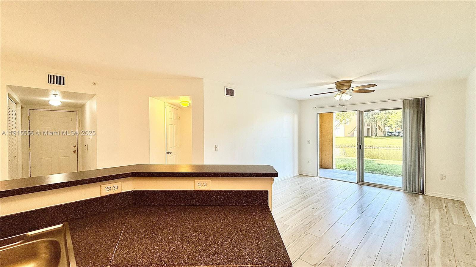 4190 San Marino Boulevard, Unit 102 West Palm Beach, FL 33409 - Photo 18 of 33 a view of a room with wooden floor and windows