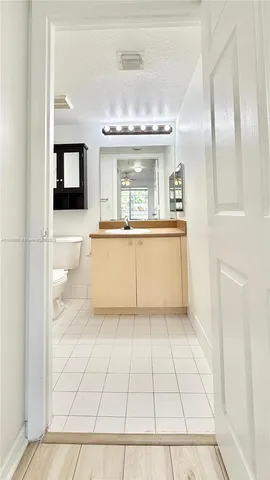 a bathroom with a bathtub shower sink and mirror