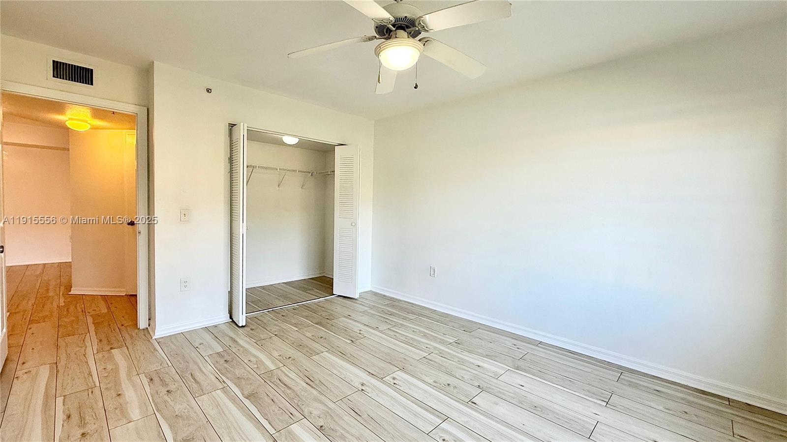 4190 San Marino Boulevard, Unit 102 West Palm Beach, FL 33409 - Photo 30 of 33 wooden floor in an empty room with a window