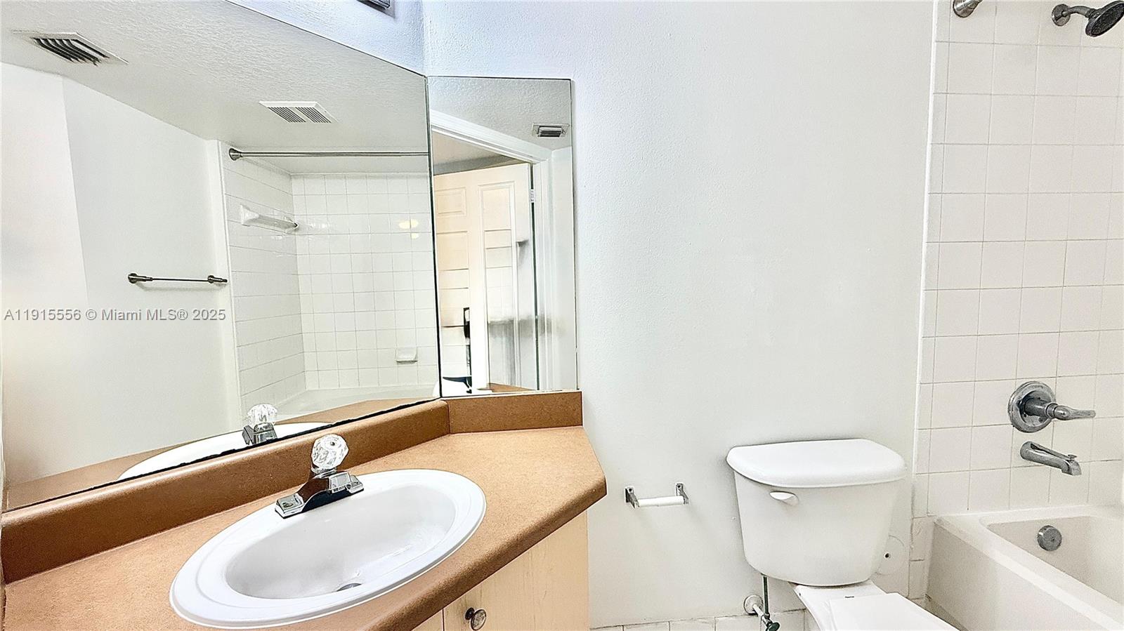 4190 San Marino Boulevard, Unit 102 West Palm Beach, FL 33409 - Photo 31 of 33 a bathroom with a sink toilet and shower