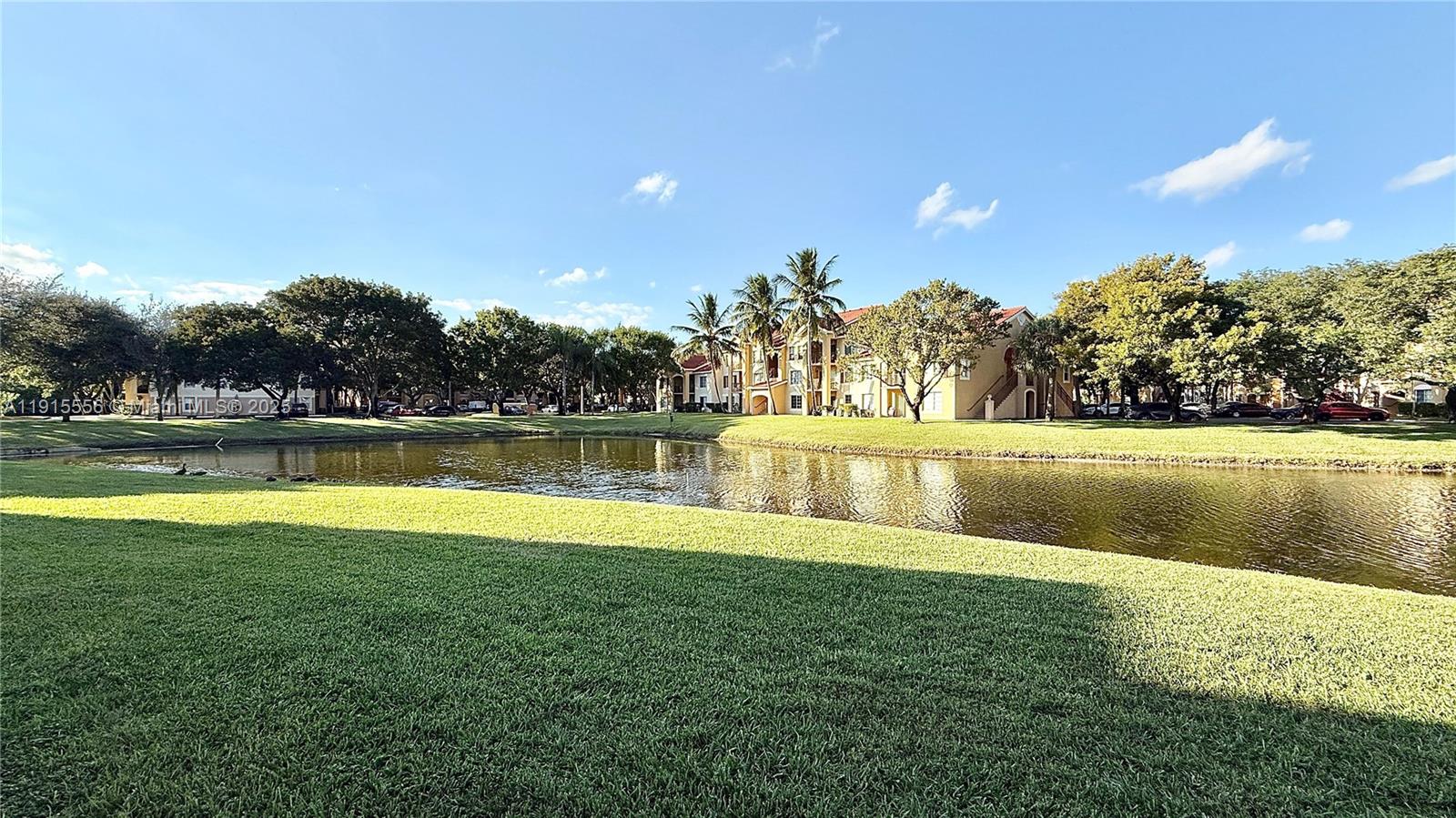 4190 San Marino Boulevard, Unit 102 West Palm Beach, FL 33409 - Photo 8 of 33 a view of a swimming pool with an outdoor space and seating area