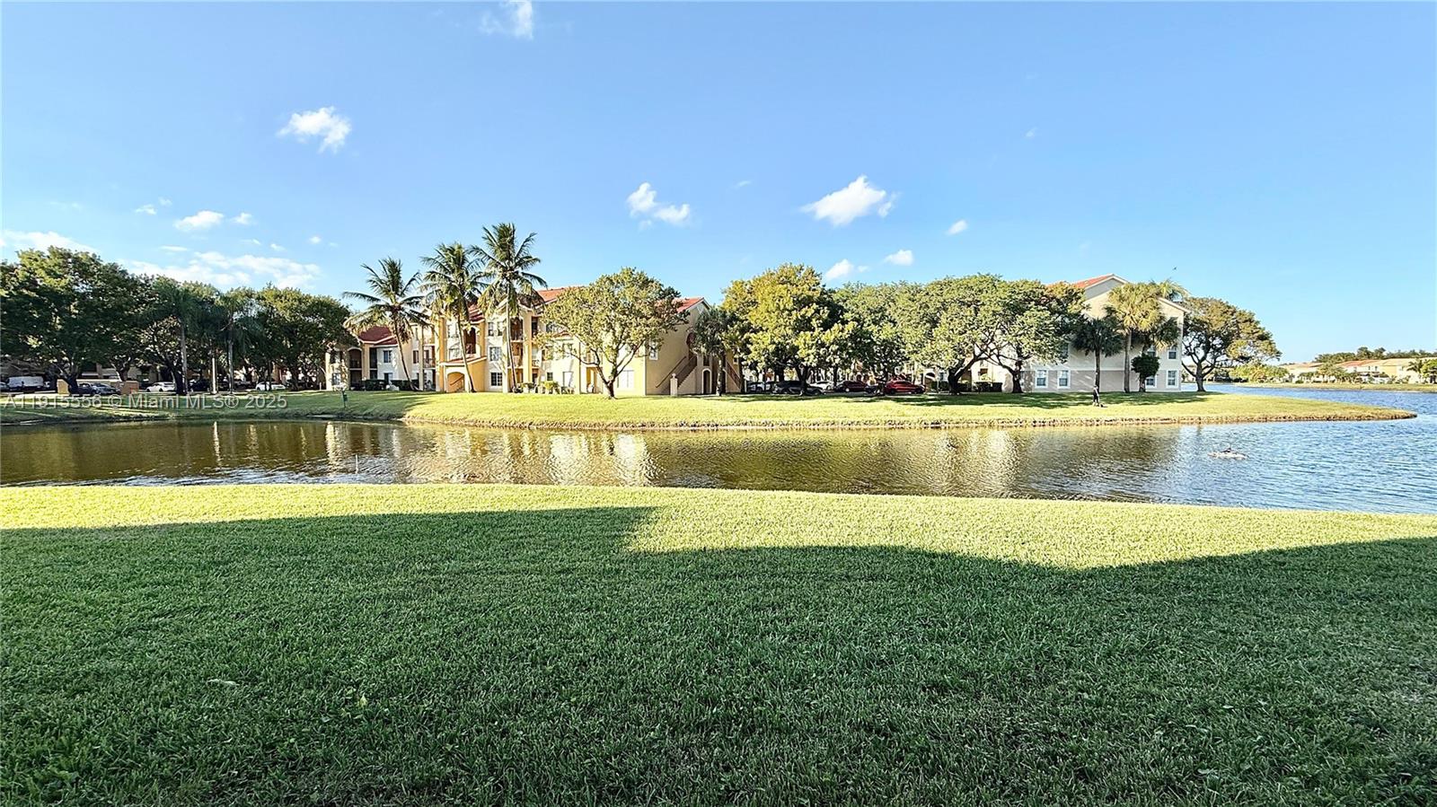 4190 San Marino Boulevard, Unit 102 West Palm Beach, FL 33409 - Photo 9 of 33 a view of a lake with a big yard
