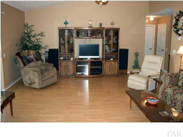 2731 River Run Road Navarre, FL 32566 - Photo 2 of 8 Family room with vaulted ceiling and laminate flooring