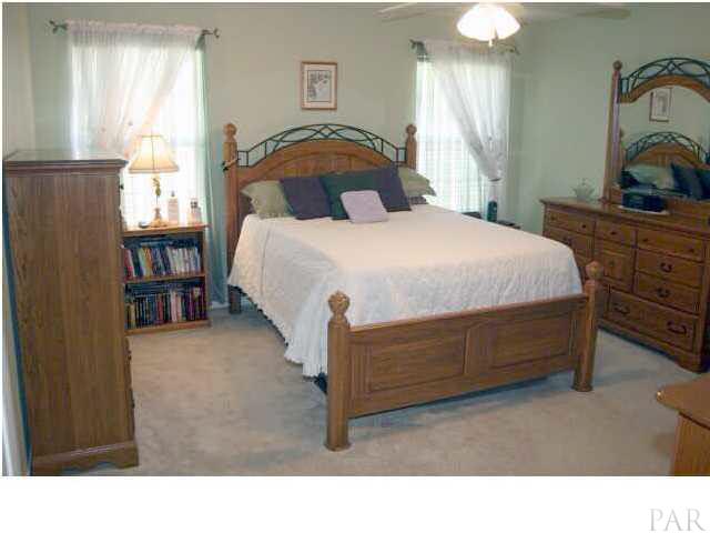2731 River Run Road Navarre, FL 32566 - Photo 5 of 8 Master bedroom with tropical colors