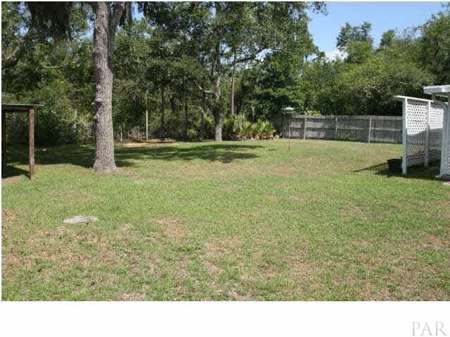 2731 River Run Road Navarre, FL 32566 - Photo 8 of 8 Shady fenced backyard with mature trees