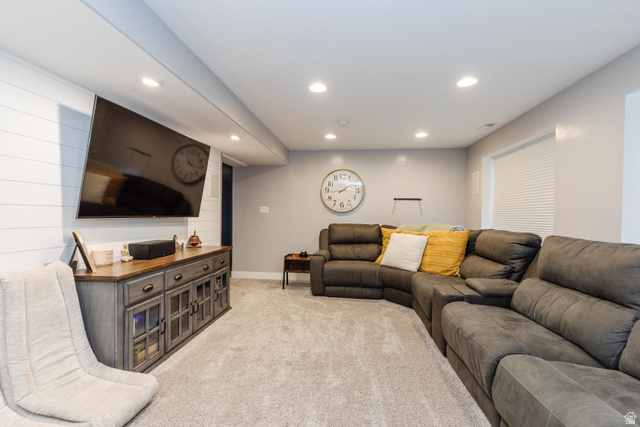 972 West 2840th Street South Logan, UT 84321 - Photo 22 of 46 Carpeted recreation room featuring recessed lighting, a window with horizontal blinds, and a built-in media console with glass-front cabinetry