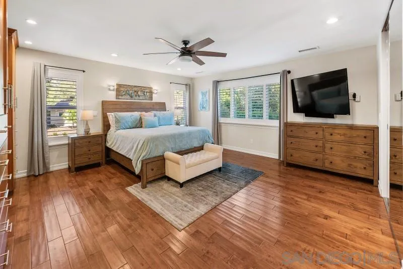 12750 McFeron Road Poway, CA 92064 - Photo 6 of 51 a spacious bedroom with a bed and a flat screen television