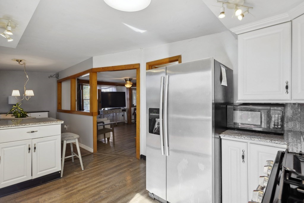 20 13th Street Wareham, MA 02558 - Photo 11 of 30 a kitchen with stainless steel appliances a refrigerator sink and cabinets