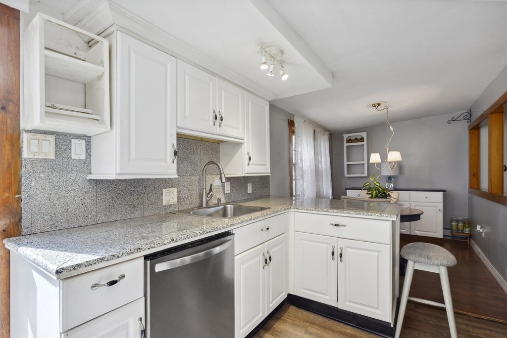 20 13th Street Wareham, MA 02558 - Photo 12 of 30 a kitchen with a sink window and cabinets