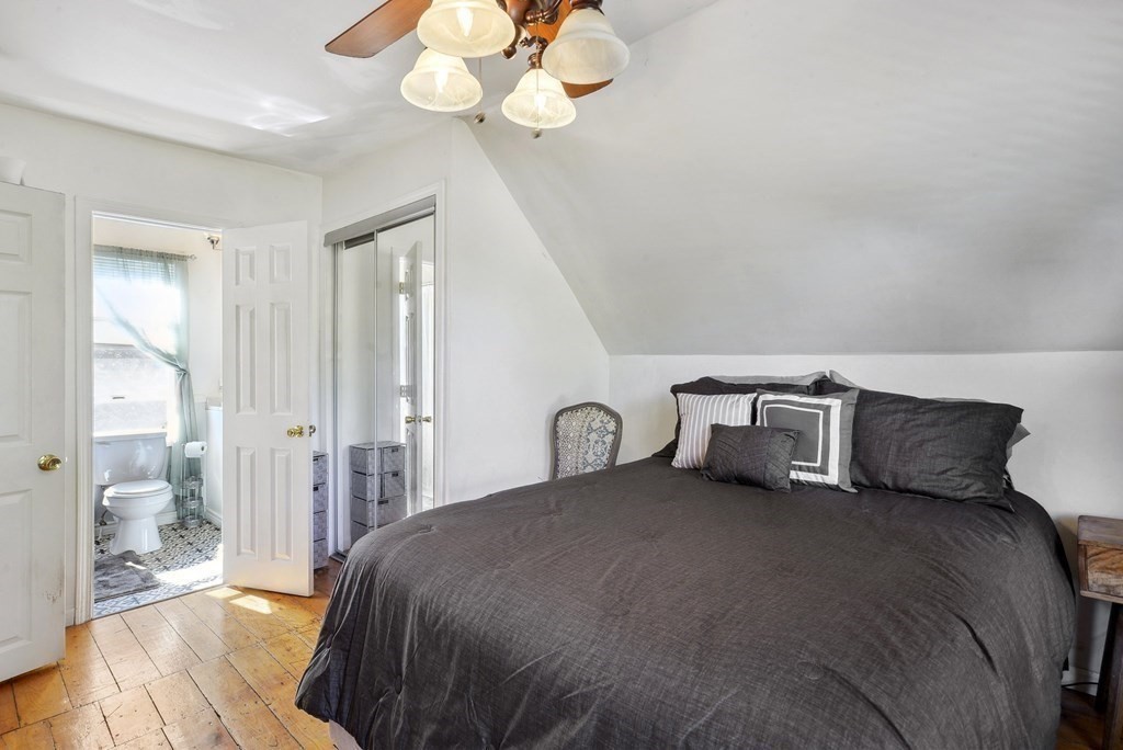 20 13th Street Wareham, MA 02558 - Photo 20 of 30 a bedroom with a large bed and a chandelier