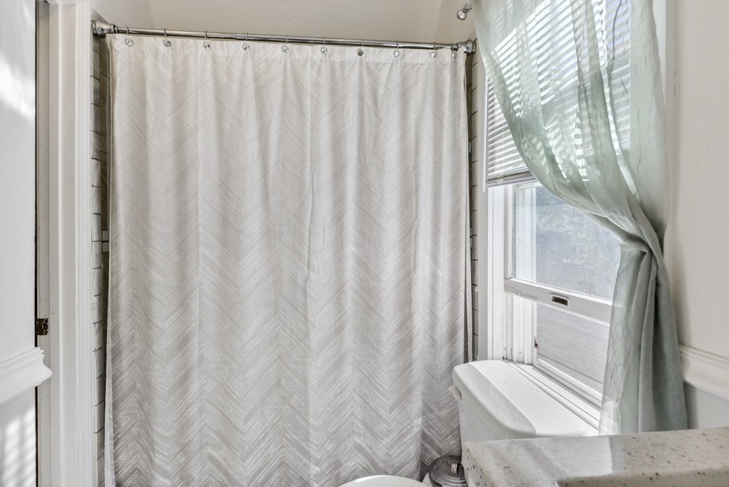 20 13th Street Wareham, MA 02558 - Photo 22 of 30 a bathroom with a shower curtain and a curtain