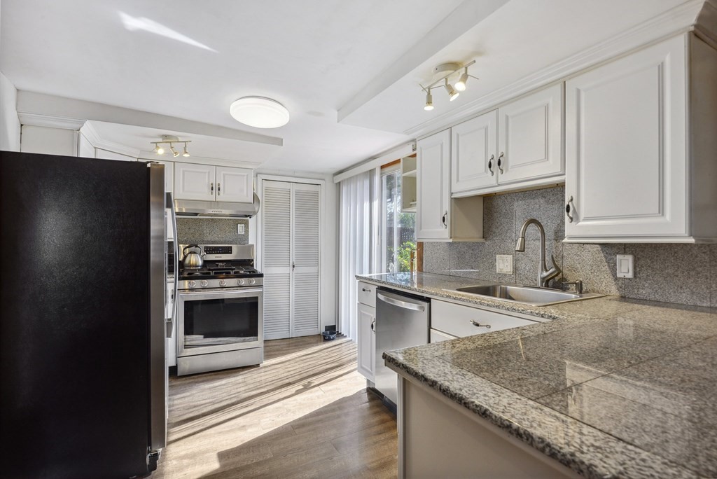 20 13th Street Wareham, MA 02558 - Photo 10 of 30 a kitchen with stainless steel appliances granite countertop a sink stove and refrigerator